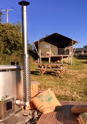 hot tub and glamping lodge in the distance.