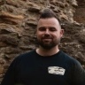 man stood in front of castle.