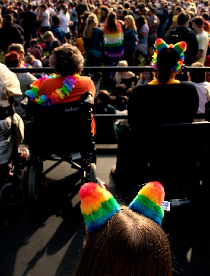 People using wheelchairs enjoying Pride Cymru.