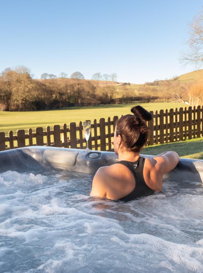 woman in hot tub with views of coutryside.
