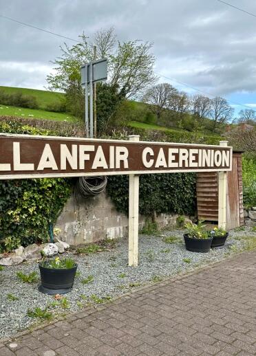 Train station sign reads 'Llanfair Caereinion'