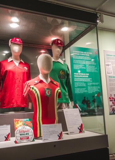 Welsh football shirts displayed in a glass cabinet