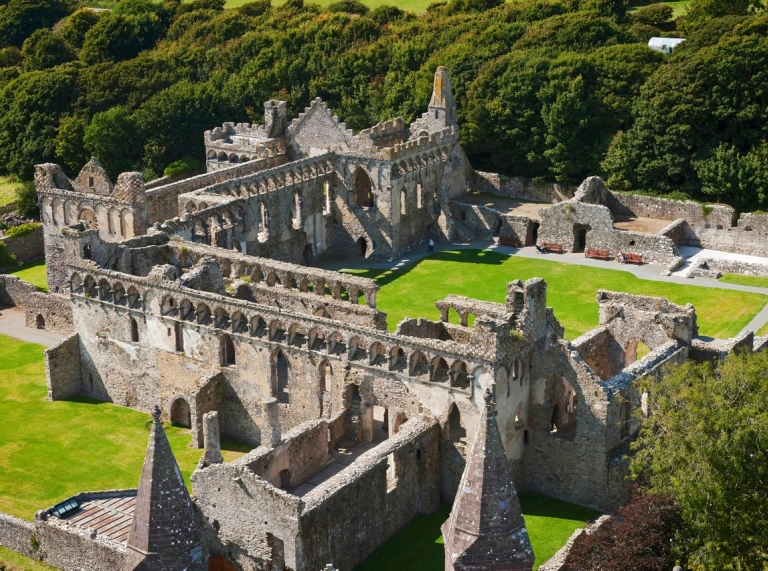 An aerial shot of the ruins of a large cathedral.