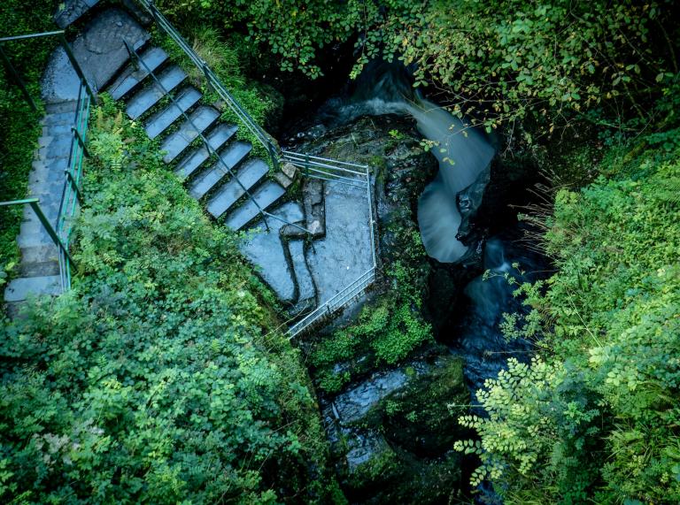 An aerial view of the steps leading down to a waterfall at Devil's Bridge.
