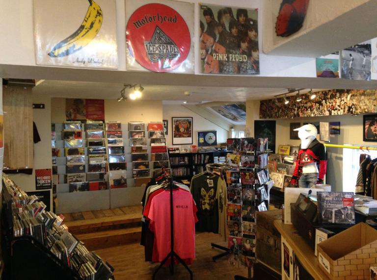 record shop interior with records and t shirts on display.