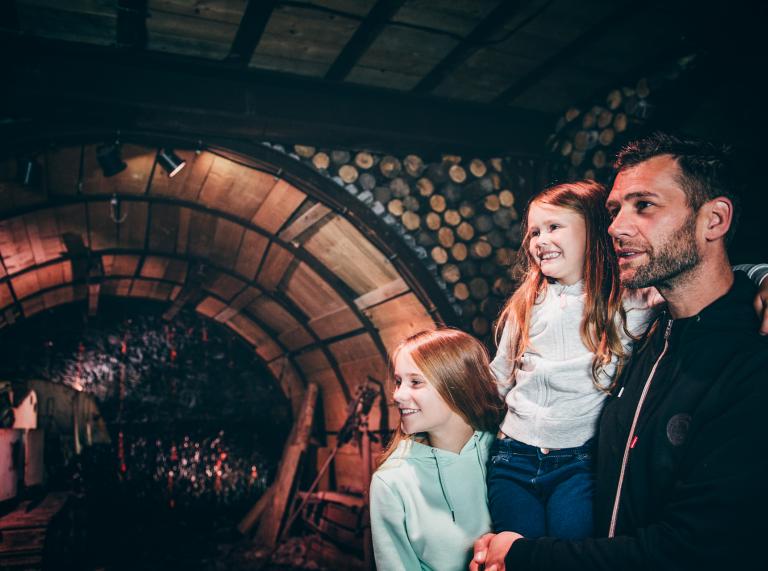 man and two girls in underground chamber at the Big Pit.