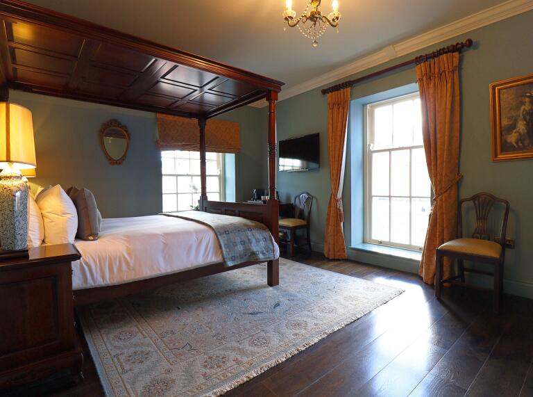 hotel bedroom with oak bed.