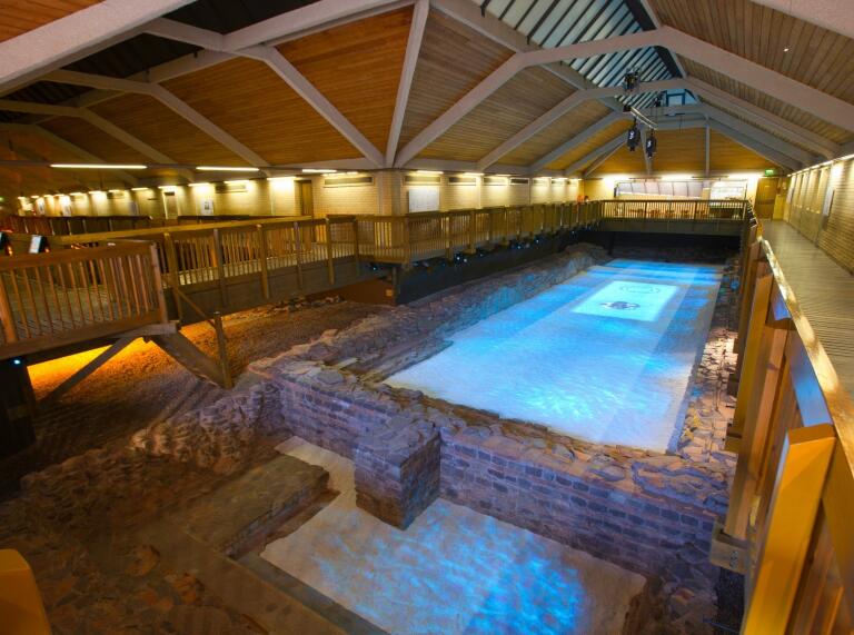 indoor pool with lights and stone walls.