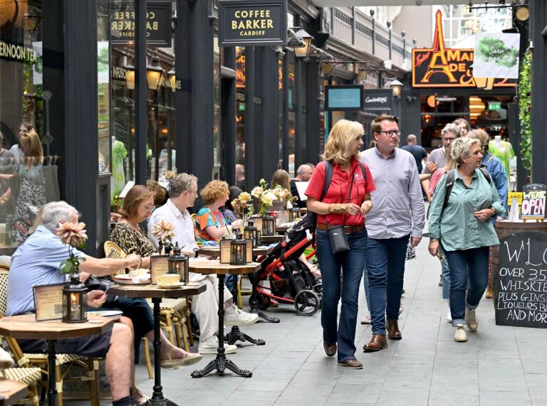 people on a food tour in a busy arcade.