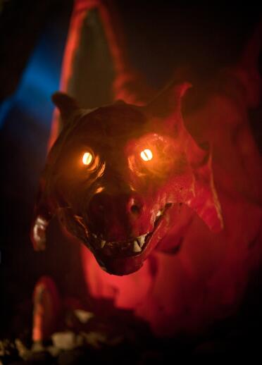 Face of red dragon with eyes lit up.