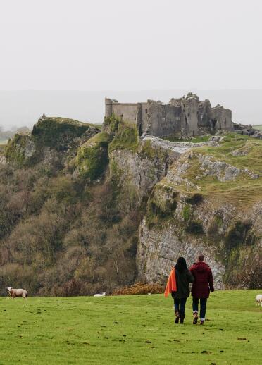 Couple walking with castle in the background.