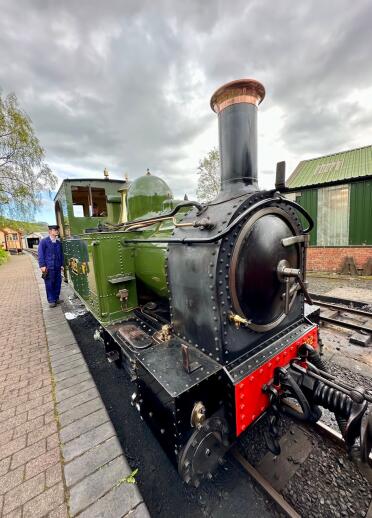 Green and black steam train. 