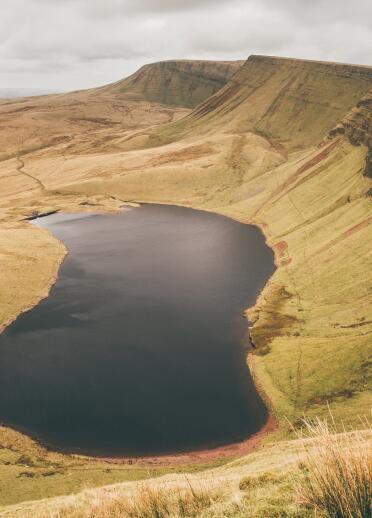 Llyn y Fan Fach from above with cloudy skies.