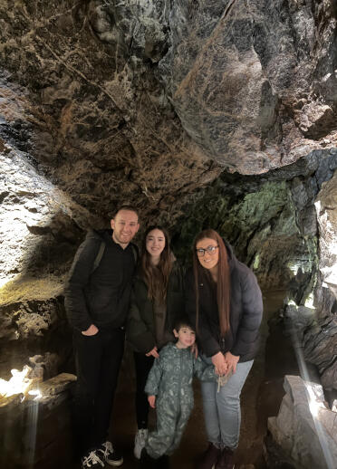 Two adults and two children in a show cave.