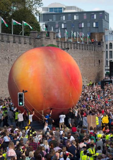 Image of a giant peach in the crowd at Roald Dahl's City of the Unexpected in Cardiff