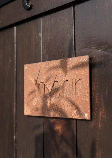 A sign on the door with the word Ynyshir.