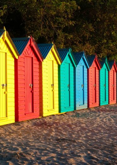 Brightly coloured beach huts.