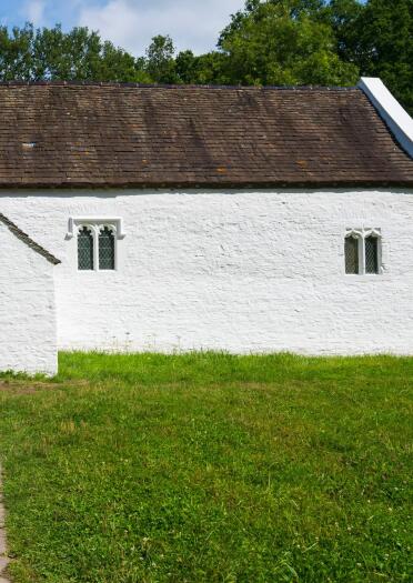 Whitewashed exterior of St Teilo's Church, St Fagans, National Museum of History, Cardiff.