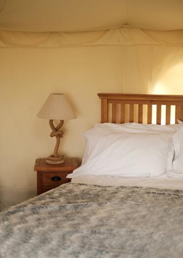 interior of yurt with bed and lamp.