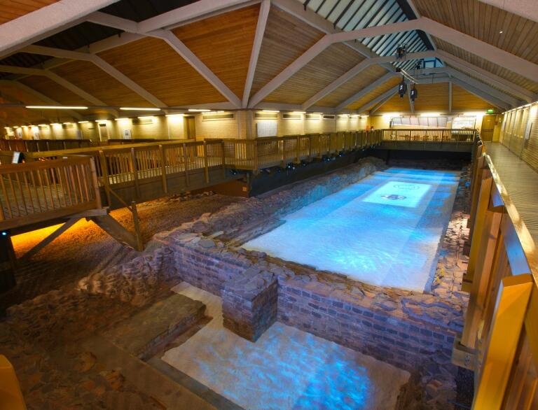 indoor pool with lights and stone walls.