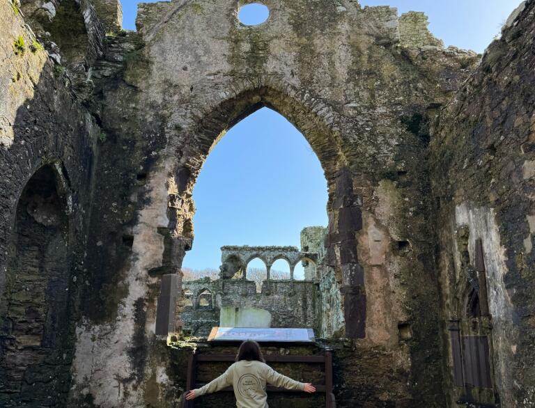 woman in Bishop's Palace ruins.
