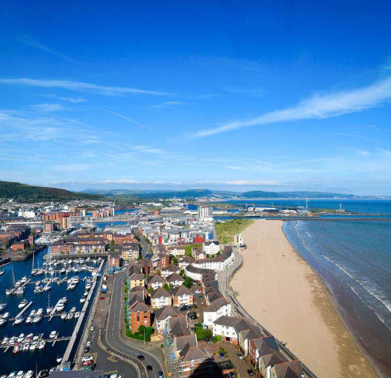 Sweeping view of the harbour and coastline of Swansea Bay.