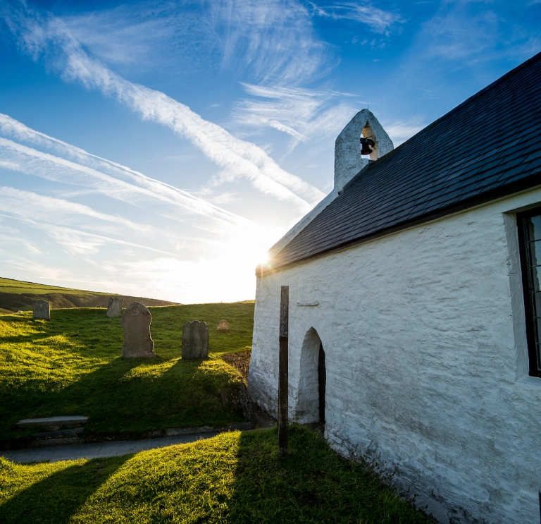 Sunny image of the side of a small whitewashed church