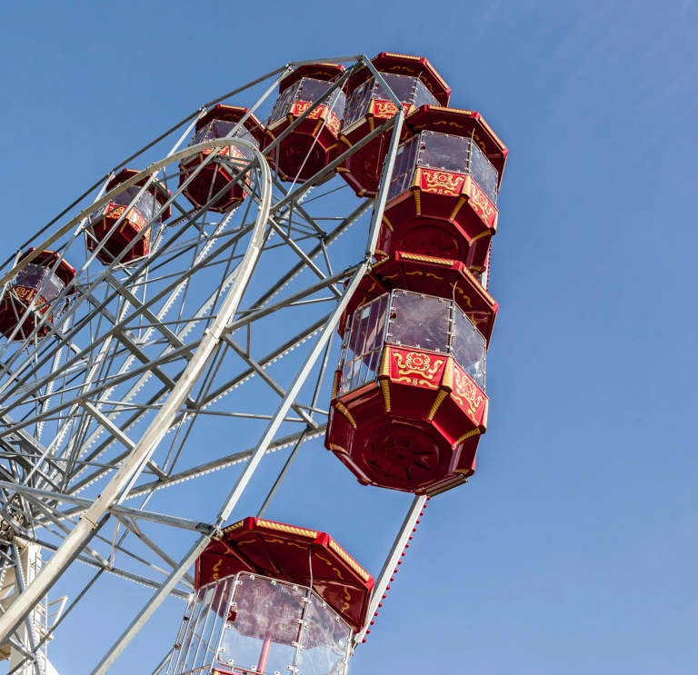 Looking up at the big wheel at Folly Farm against clear blue sky.