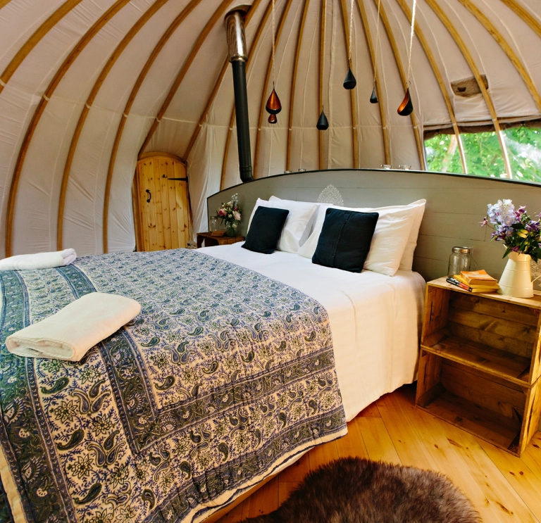 Double bed in a glamping dome.