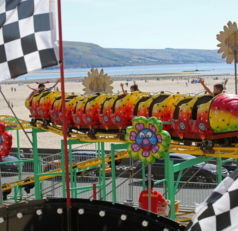 children's ride with sandy beach in background,