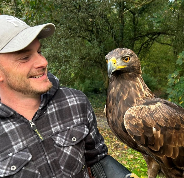 man holding bird of prey.