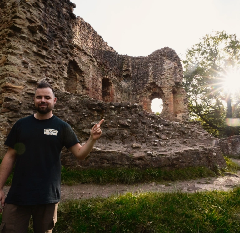 man stood in front of castle.