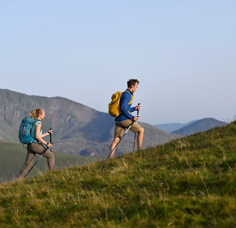 female and male walker on slope.