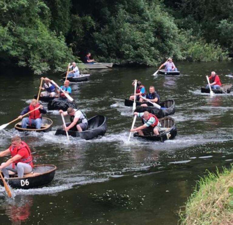 A group of people racing in coracles in West Wales.