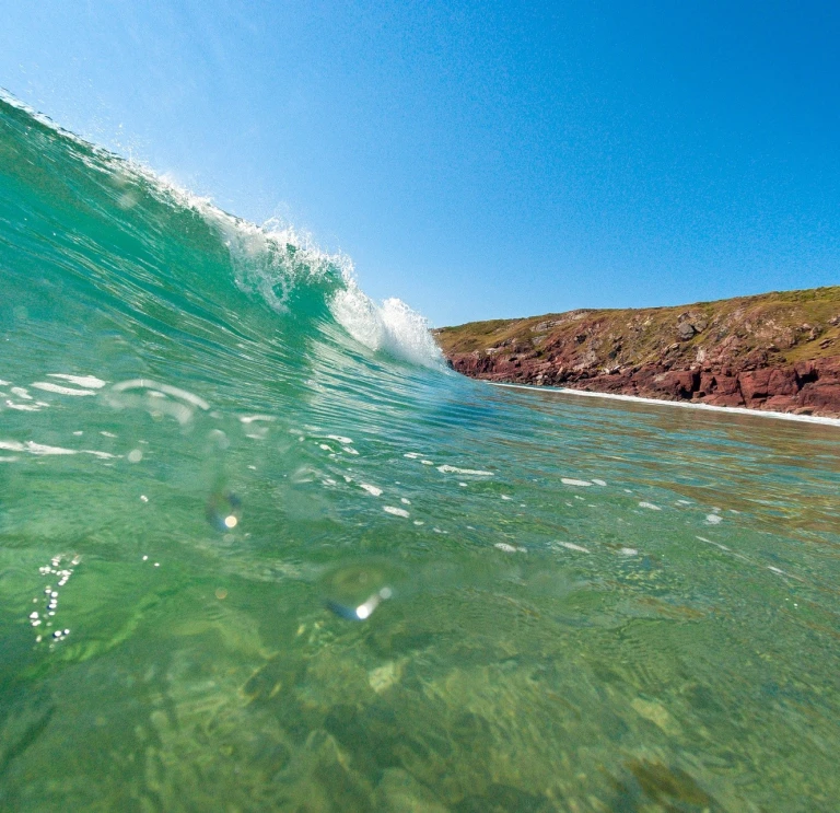 Wave crashing onto a Pembrokeshire beach.