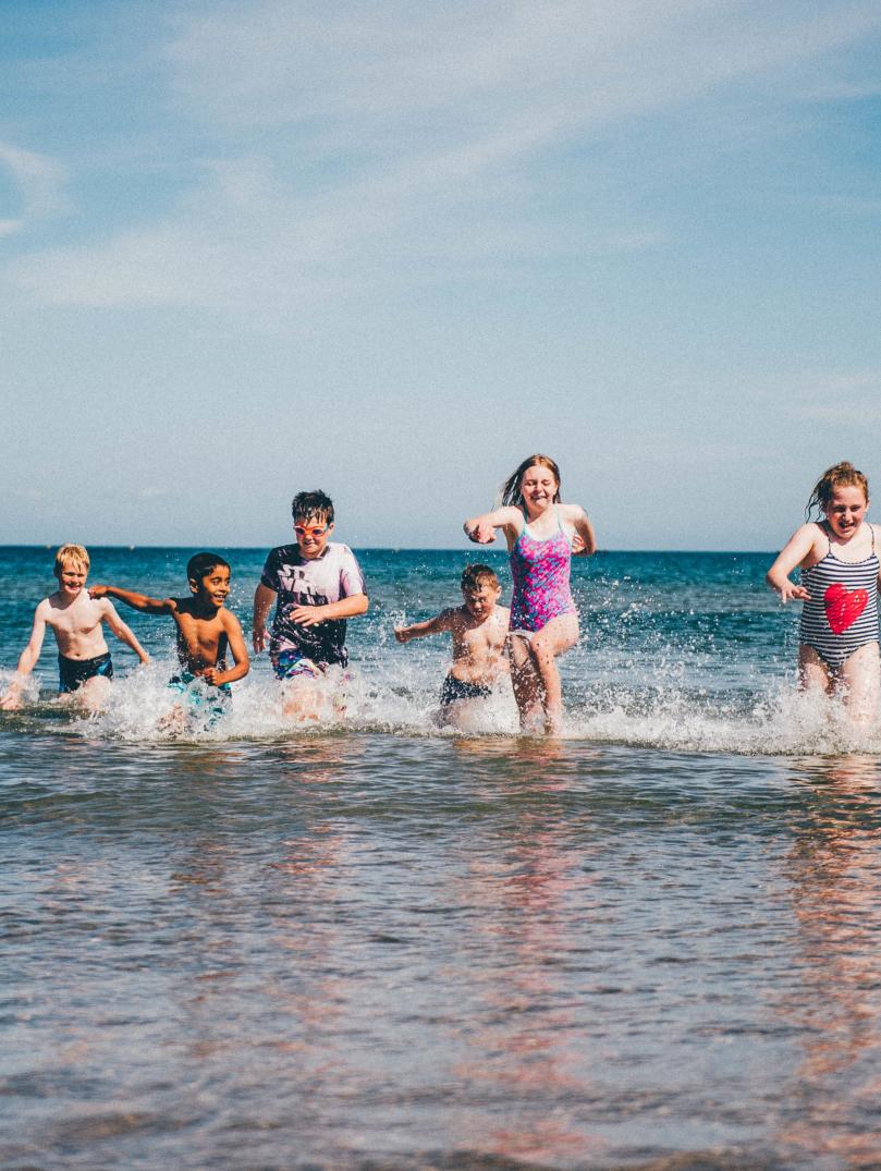 Children running in sea