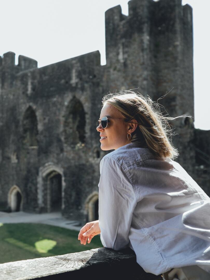 woman inside castle ruins.