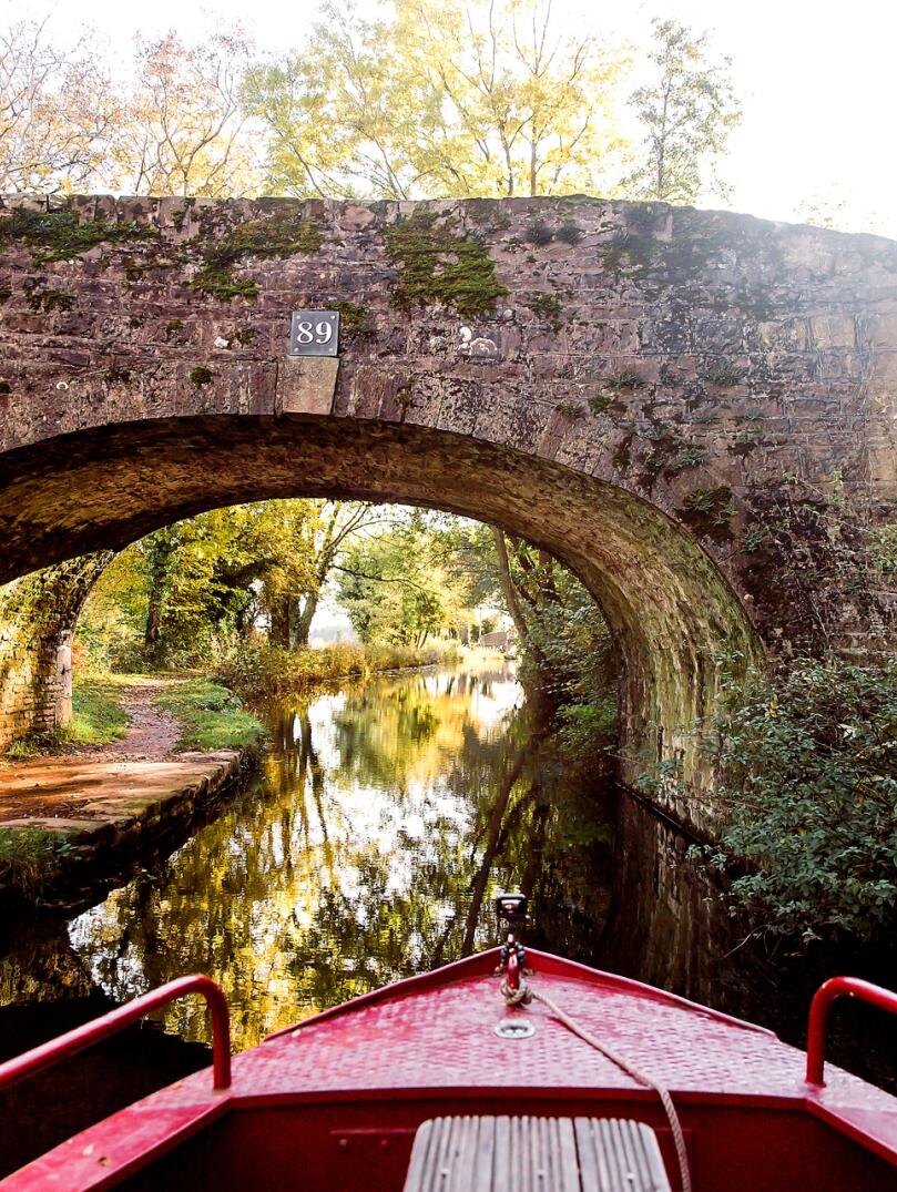 View from a narrowboat approaching a bridge.