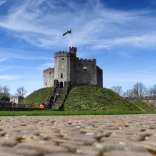 A view of The Keep tower on a grass mound taken from the cobbled footpath,.