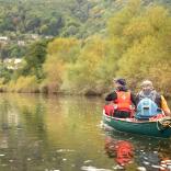 Two men canoeing down a river