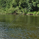 A man fishing in a river.