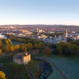 Aerial shot of Cardiff Castle with view of city.