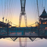 A large metal bridge at sunset.