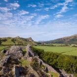 View from a ruined castle towards pastures and the coast.