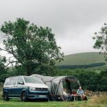 campervan and tent in field.