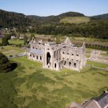 aerial view of remains of abbey with surrounding countryside.