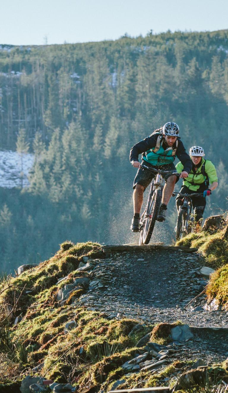 2 people riding on a mountain bike trail at Penmachno