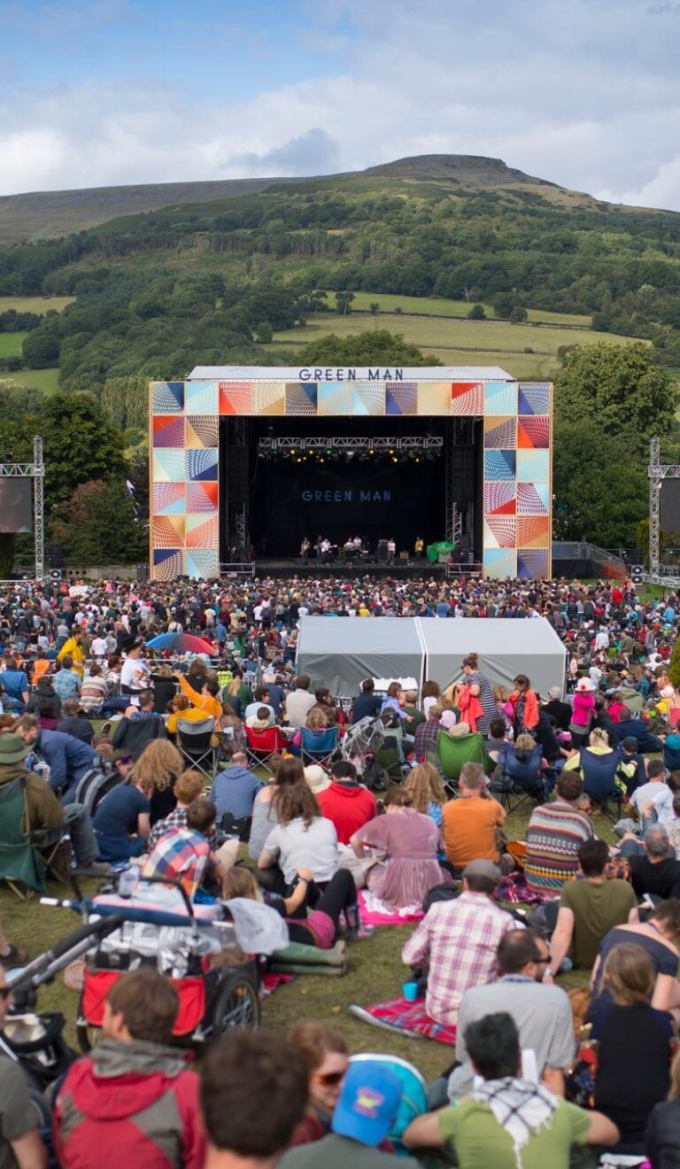 A stage at a festival in a field.